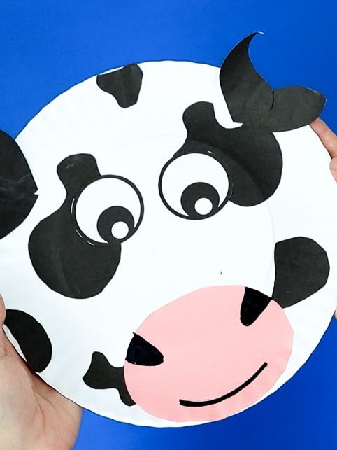 final cow paper plate craft with glued spots.